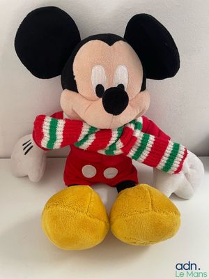 mickey mouse stuffed animal wearing a red and green striped sweater