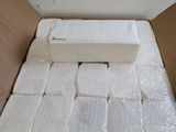 a box full of toilet paper that is in the middle of the floor