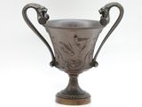 an antique silver cup with handles and handles on a white background