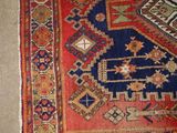 an image of a rug on the floor with a cat laying on top of it