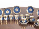 a lot of blue and white cups and saucers on a table