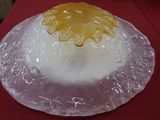 une assiette en plastique transparent ornée d'une fleur jaune