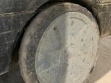 a dirty car that is parked on the side of the road