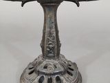an antique silver plate with a glass bowl on top of it