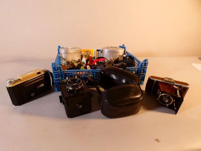 a pile of old cameras and other items on a table