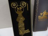 mickey mouse key in a box next to a box with a gold mickey mouse key