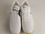 white sneakers with yellow soles on a white surface