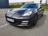the black porsche panamer is parked in a parking lot