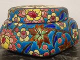 a colorful box sitting on a table with a white wall in the background