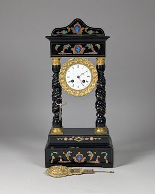 a black and gold clock sitting on top of a table