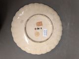 a white plate with a design on it on a table