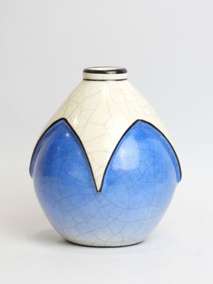 a blue and white vase sitting on a white surface