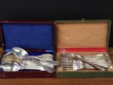 a box with silverware in it on a wooden table