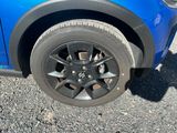 a close up of a tire on a blue car