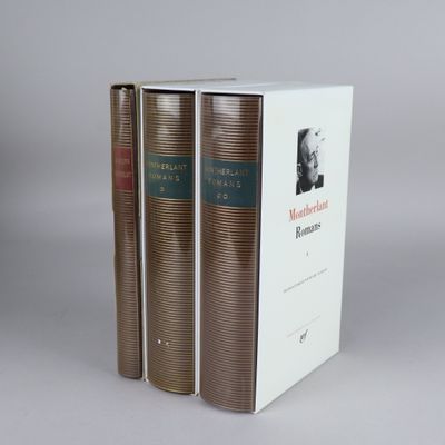 two books are stacked on top of each other in a box