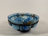 a blue bowl sitting on top of a white table