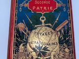 un livre rouge orné d'une bordure dorée et d'un globe terrestre
