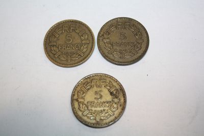 three coins are shown on a white surface with a white background
