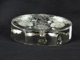 a glass box that has a flower design on it