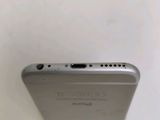 a close up of the back of a silver iphone with a camera on top of it