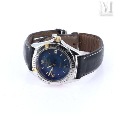 a watch with a blue dial on a black leather strap