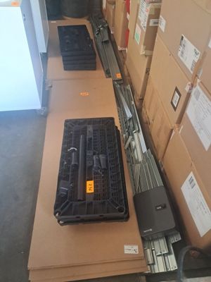 many boxes of tools sitting on a table in a warehouse