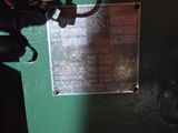 a metal plaque on the side of a green machine