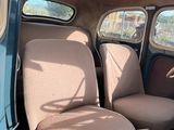 two seats in the back of a car with a steering wheel