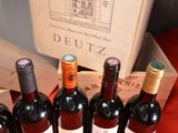 several bottles of wine are lined up in a row on a table