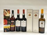 four bottles of wine are lined up in a row next to a box