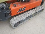 a small orange machine that is sitting on the ground