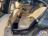 the interior of a car with the door open and the driver ' s seat down