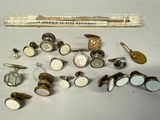 many different types of buttons and a ruler on the table
