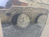 a picture of a painting of a bridge over a river