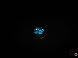 a close up of a blue diamond in the dark