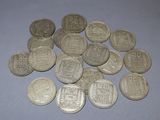a pile of silver coins sitting on a table