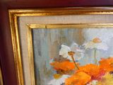 a painting of orange and white flowers in a gold frame