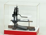 a small model of a gun in a display case