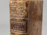 an old book sitting on top of a wooden table
