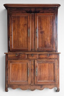 an old wooden cabinet with two doors and a drawer underneath it