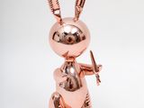 a close up of a metal rabbit statue on a white background
