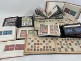 an open book sitting on top of a white table covered in stamps