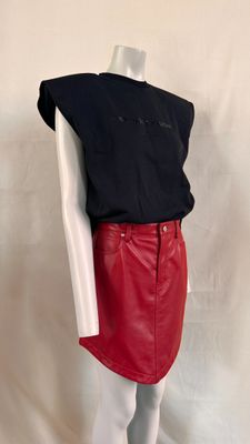 red leather skirt with black top and white shirt on a mannequin mannequin mannequin mannequin mannequin mannequin mannequin