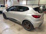 a silver car parked in a garage with other cars in the background