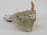 a small stone fish that is sitting on a table