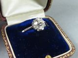 a diamond ring in a velvet box on a table