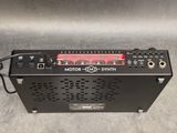 a black radio with a red light on top of it
