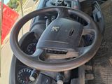 dashboard of a truck with a steering wheel and dashboard controls