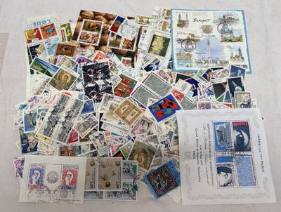 a pile of stamps on a table with a lot of them