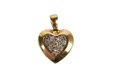 a close up of a gold heart shaped pendant with diamonds